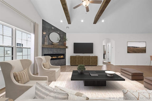 1941 W Huntsville Pl, Broken Arrow, OK 74011 - living room with beamed ceiling, ceiling fan, arched walkways, a fireplace, and light wood-type flooring