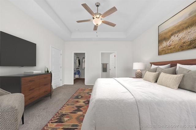 1941 W Huntsville Pl, Broken Arrow, OK 74011 - bedroom with dark colored carpet, a spacious closet, a tray ceiling, a ceiling fan, and a closet