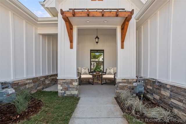 1941 W Huntsville Pl, Broken Arrow, OK 74011 - view of exterior entry featuring board and batten siding, stone siding, and a porch