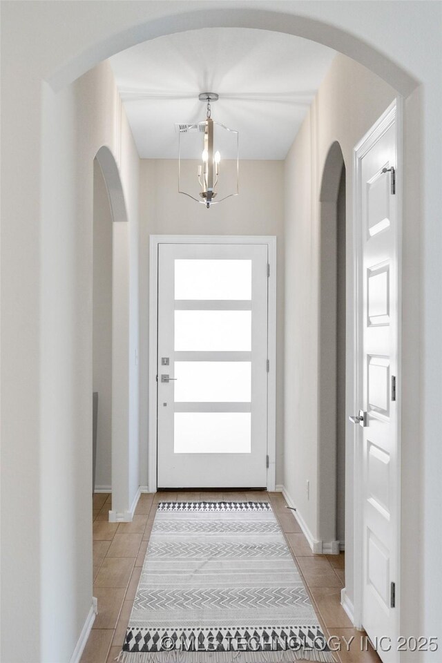 1941 W Huntsville Pl, Broken Arrow, OK 74011 - foyer entrance featuring a chandelier, light tile patterned flooring, and arched walkways