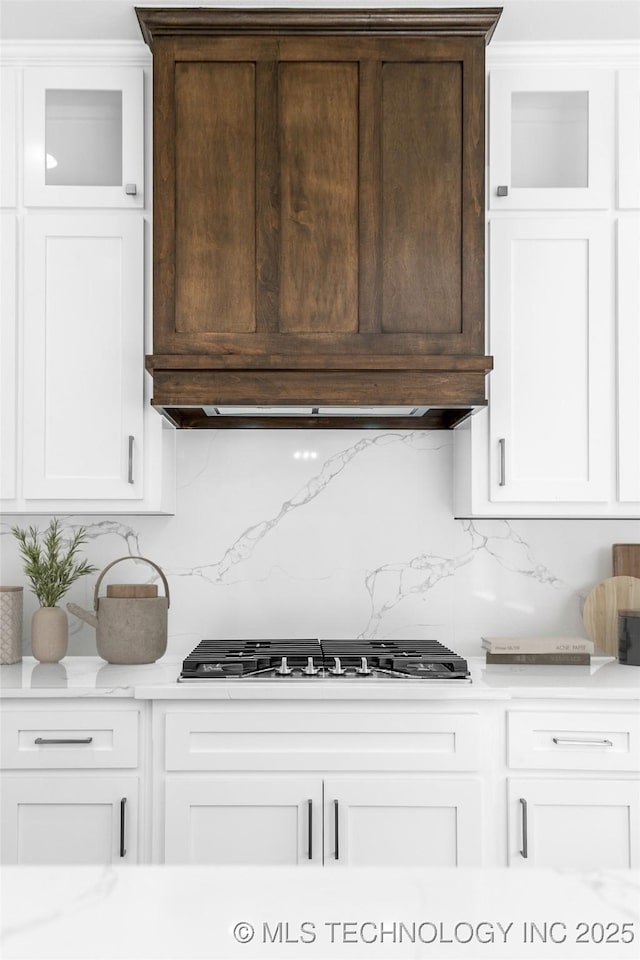 kitchen with white cabinetry, stainless steel gas cooktop, and backsplash