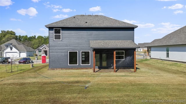 back of property with a yard and a patio area