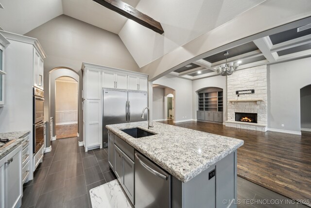 spare room featuring vaulted ceiling with beams, dark hardwood / wood-style floors, and ceiling fan