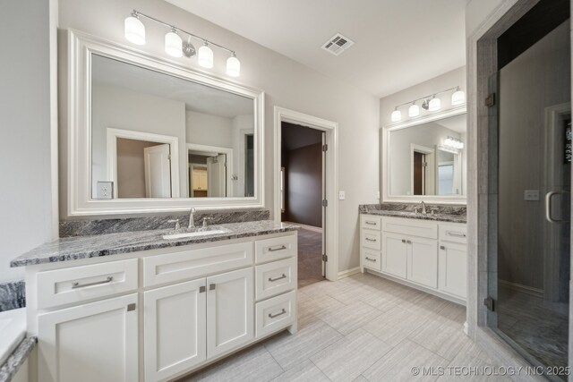 bathroom featuring vanity and an enclosed shower