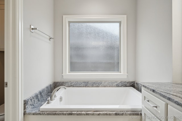 bathroom with vanity and a bathtub