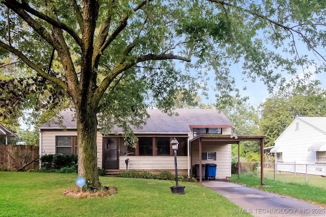 view of front of property with a front yard and a carport