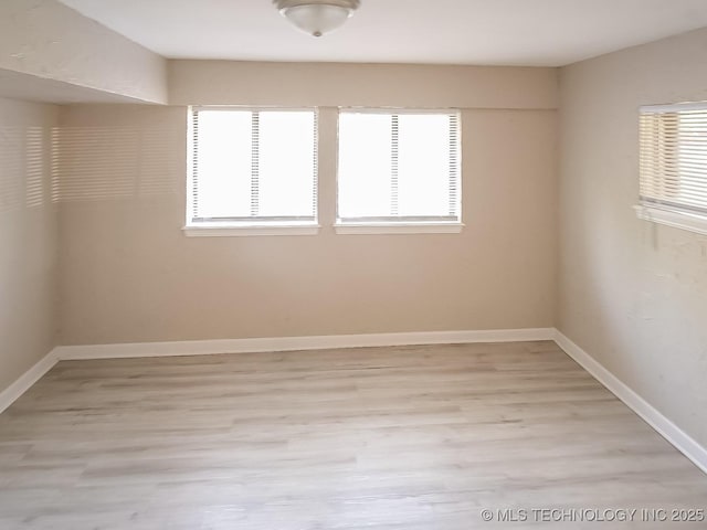 spare room featuring light hardwood / wood-style floors