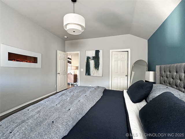 bedroom featuring vaulted ceiling