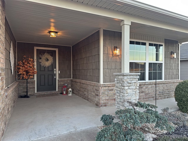 view of exterior entry with covered porch