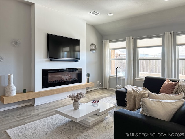 living room with lofted ceiling and light hardwood / wood-style floors