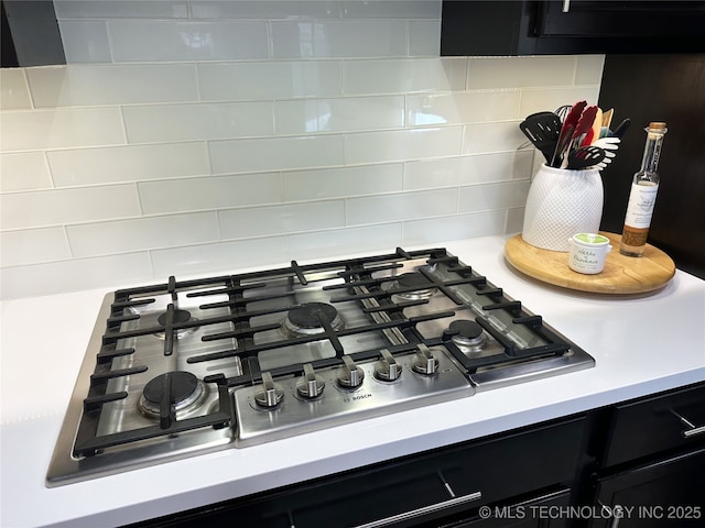 interior details featuring stainless steel gas stovetop and backsplash