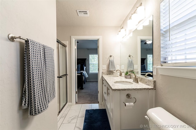 bathroom with walk in shower, vanity, toilet, and a textured ceiling