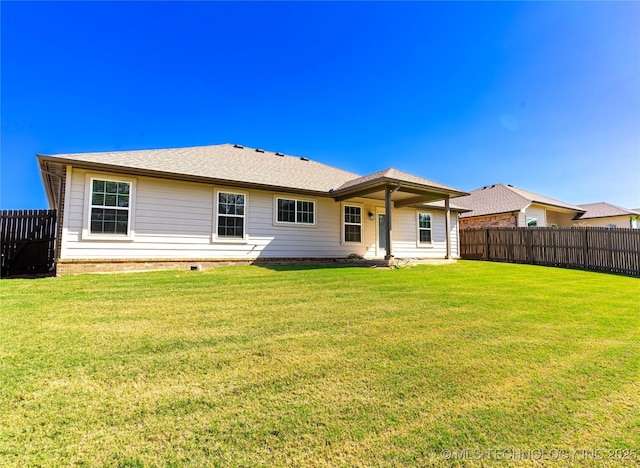 rear view of house with a yard