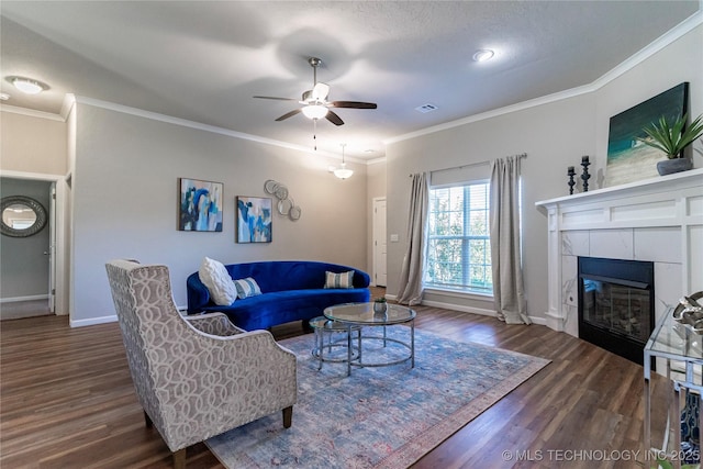 living room featuring crown molding, dark wood-type flooring, and a tile fireplace