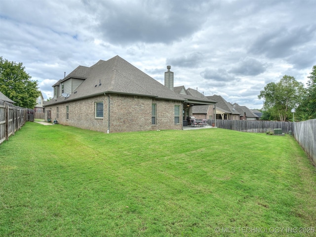 back of property with a patio area and a lawn