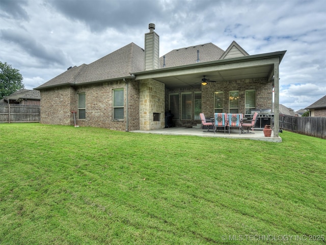 back of house with a yard, a patio, and ceiling fan