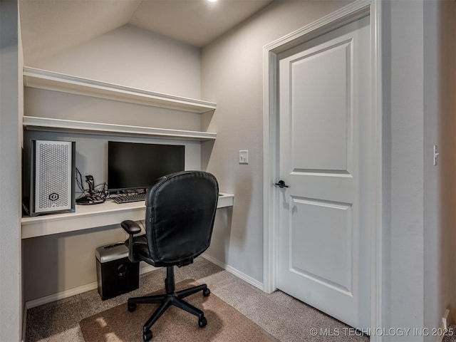 carpeted office space with vaulted ceiling