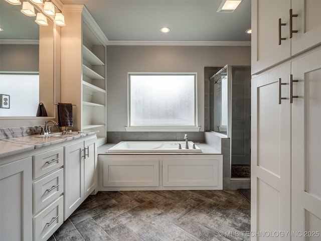 bathroom featuring plus walk in shower, vanity, and crown molding