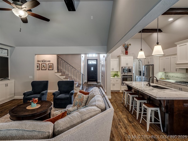 living room featuring sink, ceiling fan, beam ceiling, high vaulted ceiling, and dark hardwood / wood-style floors