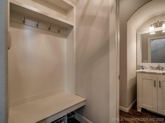 mudroom with sink and dark hardwood / wood-style floors