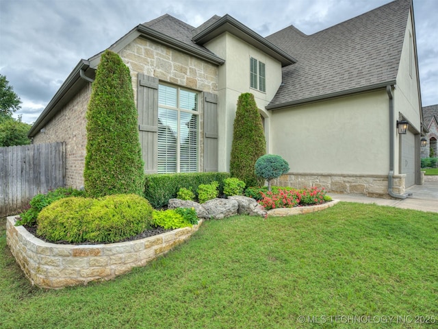 view of side of property with a lawn