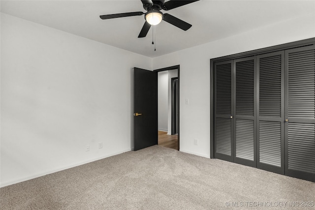 unfurnished bedroom with carpet floors, a closet, and ceiling fan