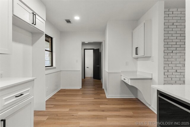 kitchen featuring light hardwood / wood-style flooring and white cabinets