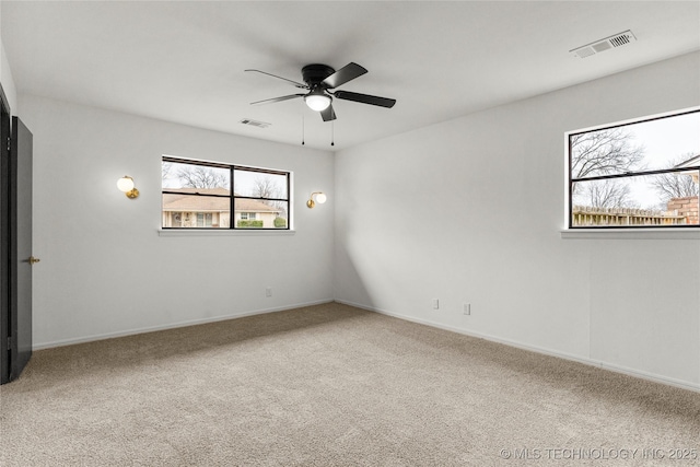 carpeted empty room featuring ceiling fan