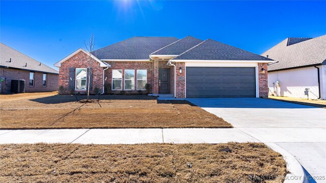 single story home featuring a garage and central AC