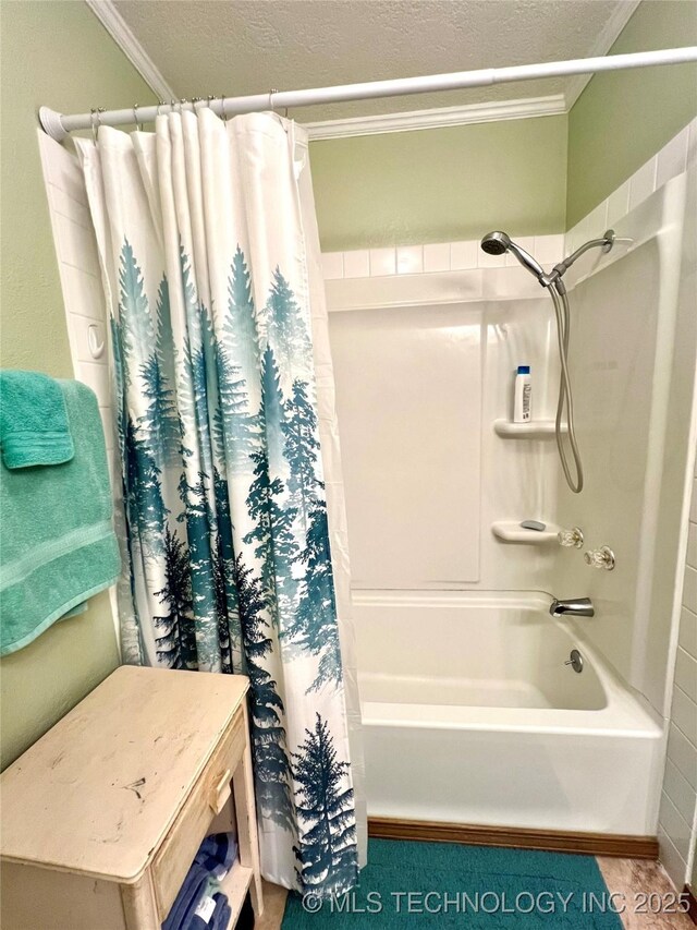 bathroom with ornamental molding, shower / tub combo with curtain, and a textured ceiling