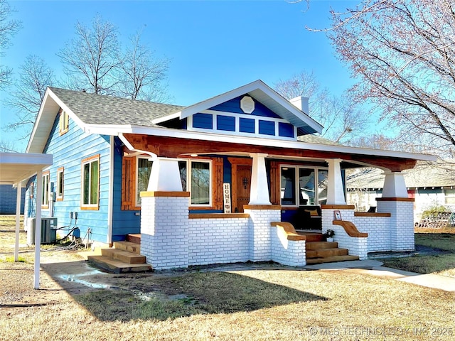 view of front facade featuring cooling unit and covered porch