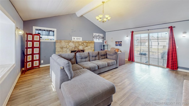 living room with an inviting chandelier, a fireplace, light hardwood / wood-style floors, and vaulted ceiling with beams