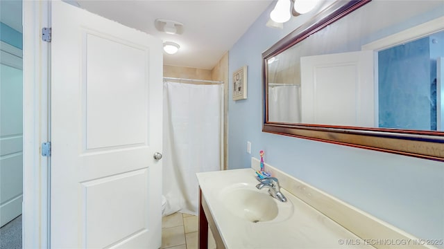 bathroom featuring vanity, a shower with curtain, tile patterned floors, and toilet