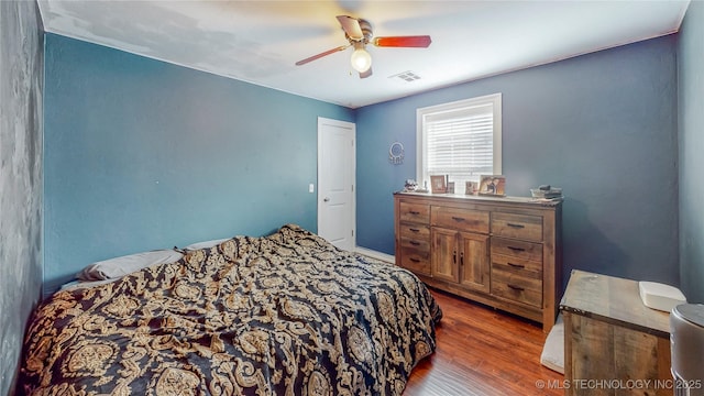 bedroom featuring ceiling fan and dark hardwood / wood-style flooring