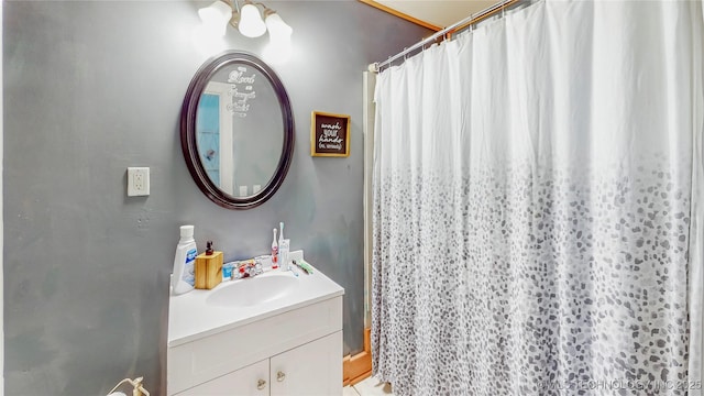 bathroom featuring walk in shower and vanity