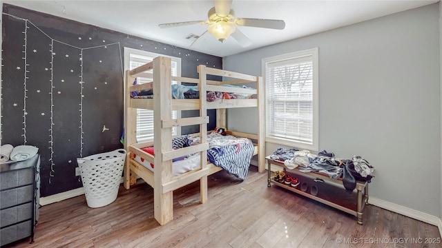 bedroom with ceiling fan and wood-type flooring