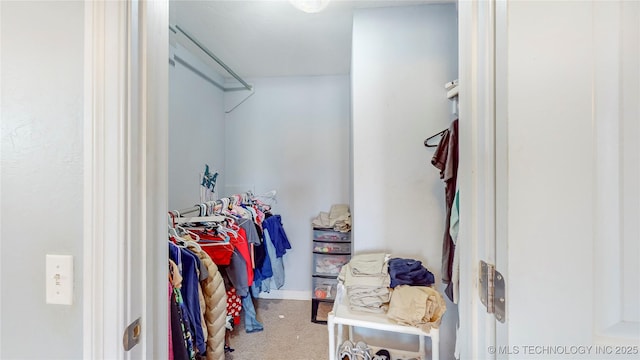 walk in closet featuring carpet flooring