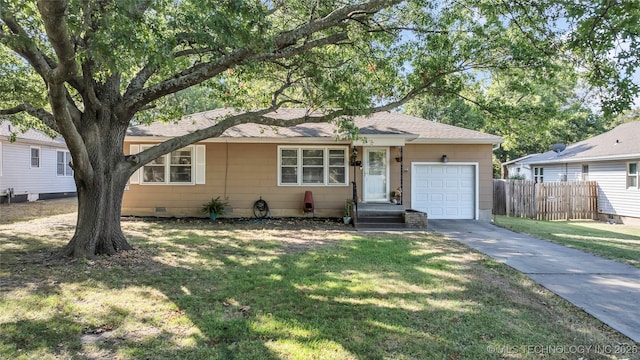 single story home featuring a garage and a front yard