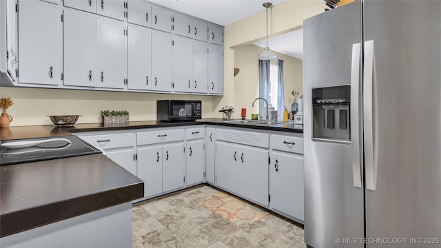 kitchen with stainless steel refrigerator with ice dispenser, sink, white cabinets, and decorative light fixtures