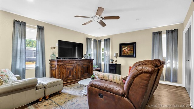 living room featuring ceiling fan and light wood-type flooring