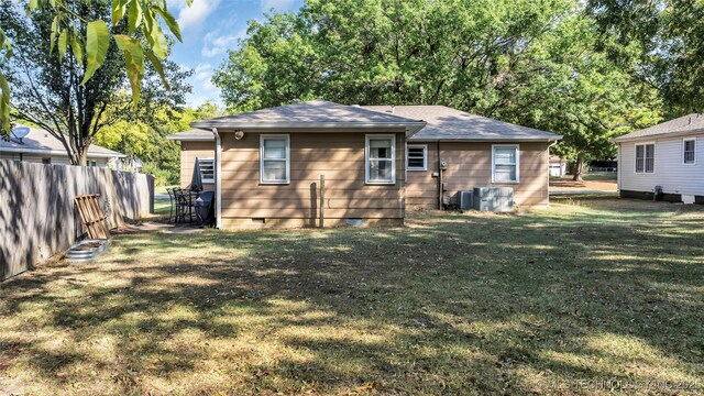 rear view of house with a lawn