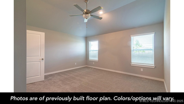 carpeted spare room with lofted ceiling and ceiling fan