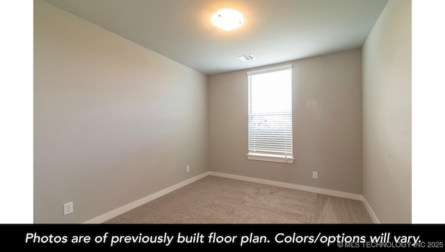 unfurnished room featuring light colored carpet