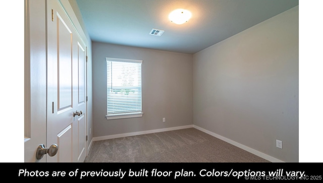 spare room featuring light colored carpet