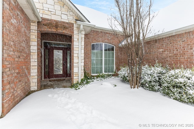 view of snow covered property entrance