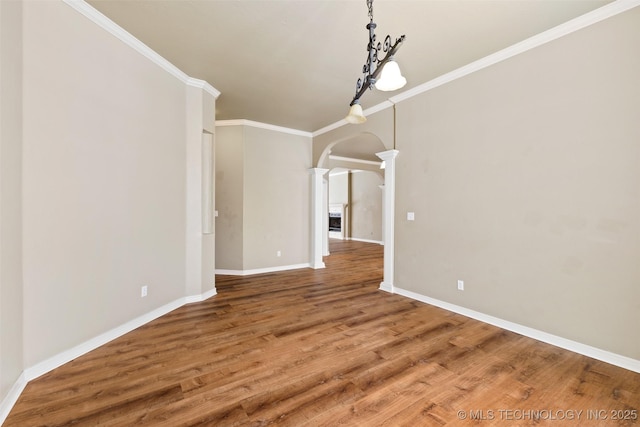 unfurnished dining area featuring decorative columns, wood-type flooring, and ornamental molding