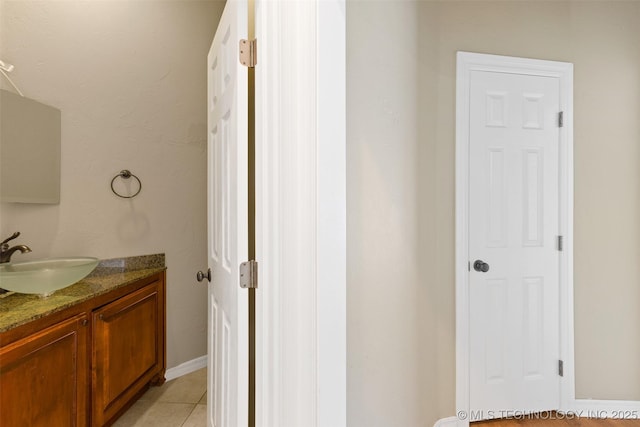 bathroom with tile patterned floors and vanity