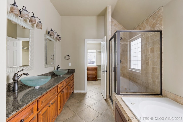 bathroom featuring tile patterned flooring, vanity, and separate shower and tub