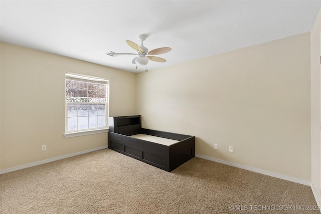 unfurnished bedroom featuring ceiling fan and carpet