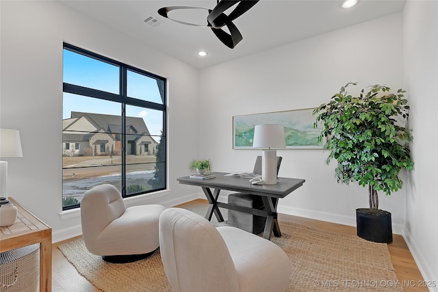 office space featuring light hardwood / wood-style flooring and ceiling fan